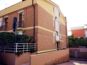 a brick building with a fence in front of it at Hotel Le Onde in Terracina
