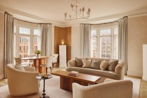 a living room with a couch and a table at Claridge's, Maybourne in London