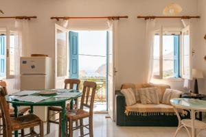 a kitchen and living room with a table and a couch at Villa Dimosthenis in Symi +32 photos