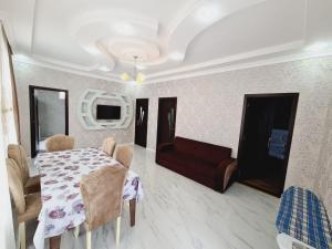 a living room with a table and a red couch at Aksn new small villa in Gabala