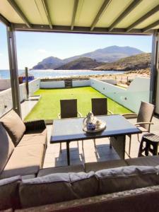 a living room with a couch and a table at Marilous House - Skyros Beachfront Getaway in Skiros