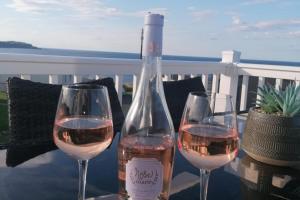 two glasses of wine sitting on top of a table at 3-Bed Lodge with SeaView-Fireplace-Garden-FreeP in Eyemouth +26 photos
