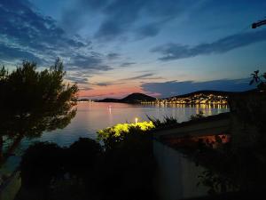 a view of a large body of water at night at Tisno Sea View apartment in Tisno