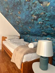a bedroom with a bed with a fish mural at RELAX Apartman in Nyíregyháza +48 photos