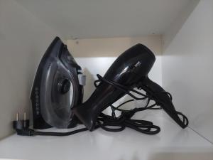 a pair of boots and a computer monitor on a shelf at The Mastiha Spot 4 in Chios