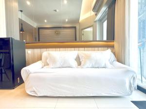 a bed with white sheets and pillows in a room at Charming 2BR Apartment at Amor Pakuwon City Mall East Surabaya by Le Ciel Hospitality in Surabaya +23 photos