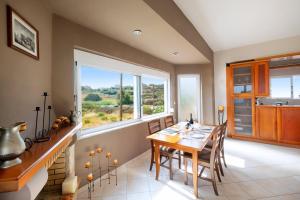 a dining room with a table and a large window at Nektar Luxury Apartment in Stalos
