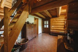 a kitchen with wooden walls and stairs in a cabin at Šumavská Vlčice - Rybářský srub in Strážný +2 photos