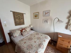 a bedroom with a bed and a lamp in it at Elegant 4-Bed Pet-Friendly Retreat in Snowdonia in Conwy
