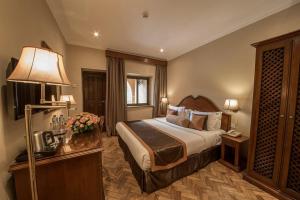 a hotel room with a bed and a lamp at URBAN STaR HOTEL in Kampala