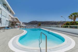 een zwembad aan de zijkant van een gebouw bij Brisas Canarias in Puerto Rico de Gran Canaria