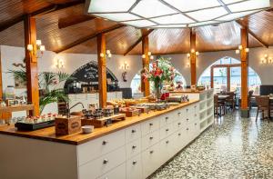 a restaurant with a counter with food on display at Mesón Castilla Atiram Hotels in Barcelona +79 photos