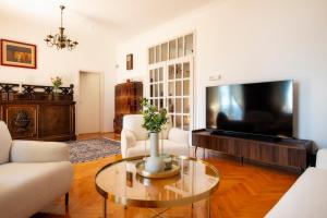 a living room with a tv and a table at Villa Mediteran in Split