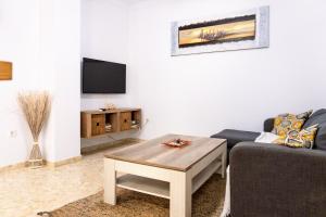 a living room with a couch and a coffee table at RIO SECO LOFT BEACH- HOME RENt MALAGA in Torre del Mar