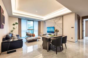 a living room with a table and chairs and a couch at 故渝里两室两卫 in Chongqing