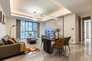 a living room with a couch and a table and chairs at 故渝里两室两卫 in Chongqing