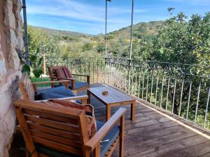 a balcony with chairs and a table and a view at tranquil beautiful house כליל השחר- צימרים קסומים במיקום מרגיע למשפחות וזוגות in Clil