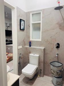 a bathroom with a toilet and a sink at NZ Luxury Villa's # 3 in Mohali +16 photos