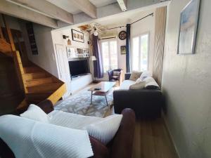 a living room with two couches and a television at Reve azur plage en duplex coeur de village in Le Pradet
