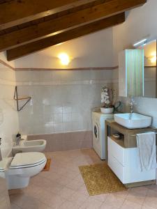 a bathroom with a toilet and a sink at Casa Mauro in Gravedona +48 photos