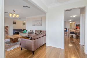 a living room with a couch and a table at Whisper on the Falls in Wentworth Falls +15 photos