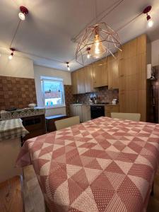a kitchen with a table with a checkered table cloth at Oma Nani in Campitello di Fassa