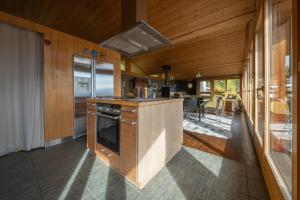 a kitchen with a stove and a counter top at Chalet Occursus Anzère in Anzère