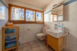 a bathroom with a sink and a toilet at Chalet Occursus Anzère in Anzère +52 photos