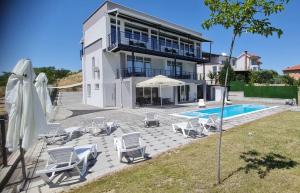 a villa with a swimming pool and a house at Tashev Apartments in Veles