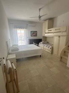 a bedroom with two beds and a window at BRUNETTI HOLIDAY due in Torre Ovo