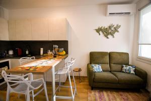 a kitchen with a couch and a table in a room at Casaluna in Udine