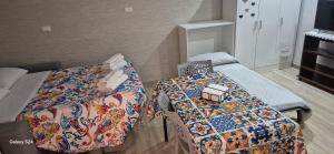 a room with a bed and a table with a quilt at Sweet Home Sofia in Barletta
