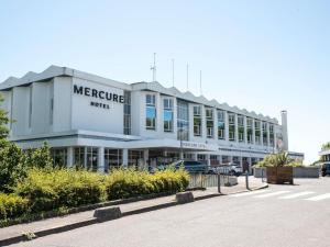 a large white building with a sign on it at Mercure Nevers Pont De Loire in Nevers