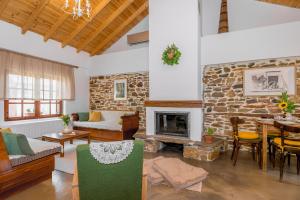 a living room with a fireplace and a stone wall at Plismoní in Alexandroupoli +2 photos
