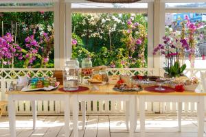 a table with food on it in a room with flowers at Pensione Silvia Santa Marì in Ponza