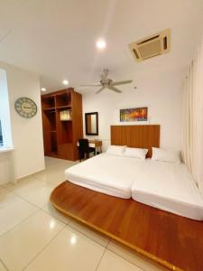 a bedroom with two beds and a ceiling fan at Mansion One studio in George Town