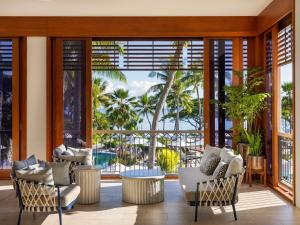 a living room with a view of the ocean at Sofitel Fiji Resort & Spa in Denarau