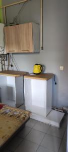 a kitchen with white cabinets and a yellow bowl on a counter at GELENA Бутік - готель in Uzhhorod