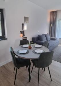 a living room with a table with chairs and a couch at TETRA Plus 569 in Breaza