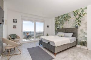 バールにあるStudio Apartments Olgaの大きなベッドと大きな窓のある寝室