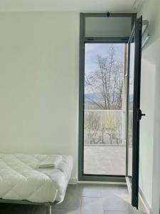 a bedroom with a bed and a sliding glass door at UBA Hostel in San Sebastián +29 photos