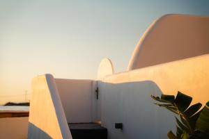 a view from the balcony of a house with a plant at Divino Caldera in Akrotiri