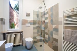 a bathroom with a toilet and a glass shower at Garavaglia Uno in Pavia +11 photos