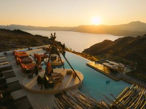 a view of a boat in the water at sunset at Divino Caldera in Akrotiri