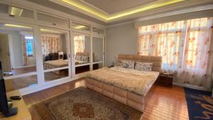 a bedroom with a bed and a large window at Azure Homestay in Srinagar