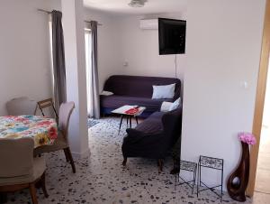 a living room with a couch and a table at Dubravka 3 in Luka