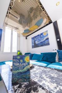 a living room with a blue couch and a table at Duplex suite 50m de la plage Carré d'Or Nice in Nice