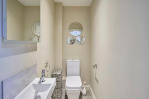 a bathroom with a white toilet and a sink at Host & Stay - The Sett in South Wootton +15 photos