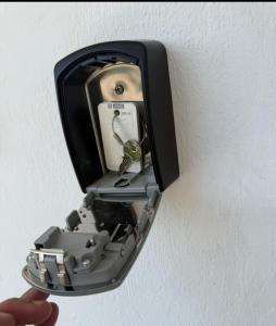 a person holding a electronic device in a wall outlet at seasideepanomi in Epanomi