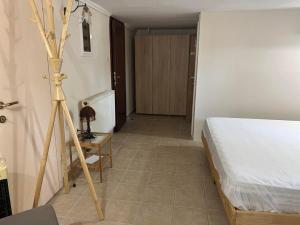 a bedroom with a bed and a tripod in a room at Angel Home Steps from the Sea in Nea Kallikrateia